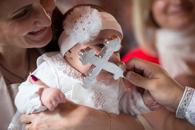 The baptism of a child.The little girl was borne a cross