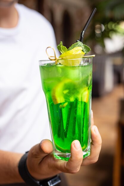 Bar Lemonade with fruit in the hands of a bartender