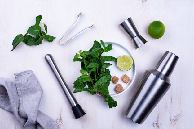 Bar tools, lime and mint for prepare cocktail