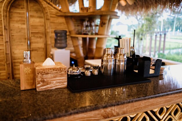 A bar with a wooden box on the counter that says bar at the top.