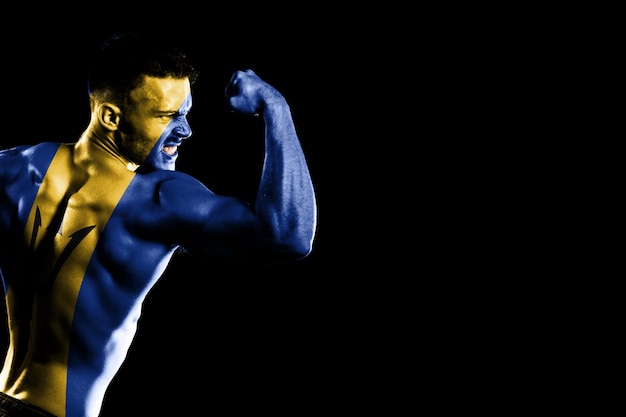 Barbados flag on handsome young muscular man black background