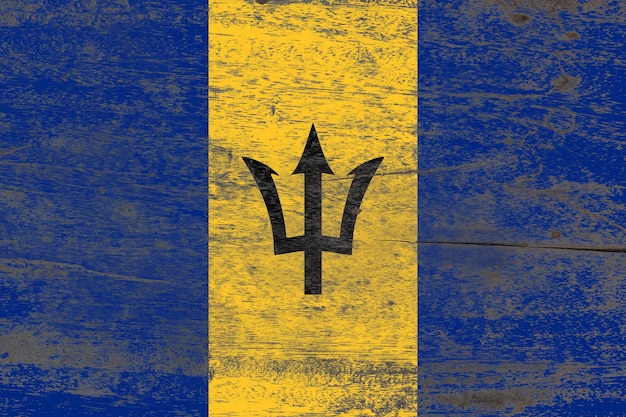 Barbados flag painted on a damaged old wooden background