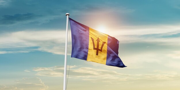 barbados national flag waving in beautiful sky