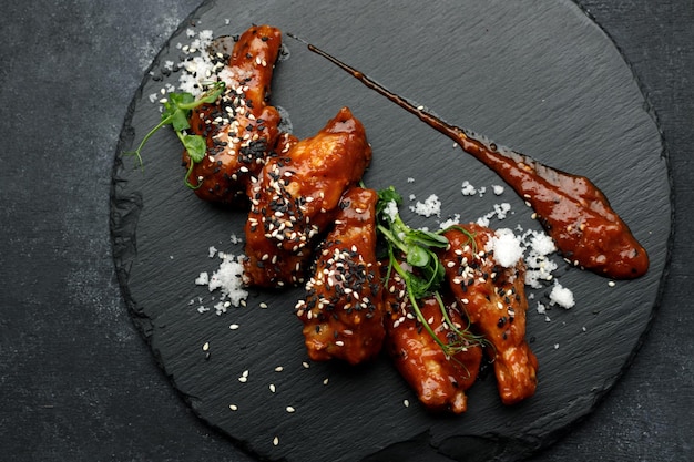 Barbecue chicken wings on a black stone