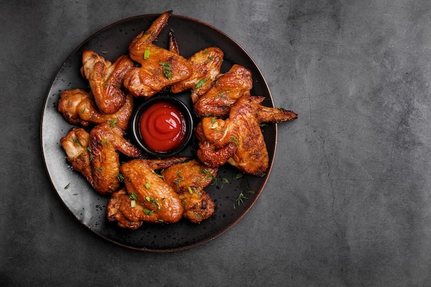 Barbecue chicken wings on  table Top view Fried chicken closeup