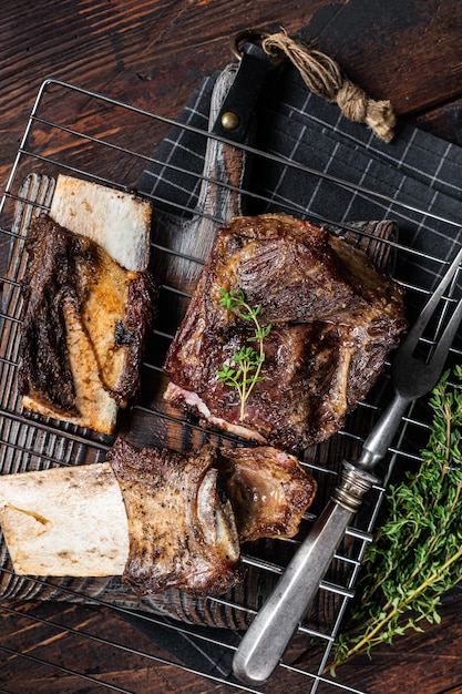 Barbecue chuck beef short ribs on grill wooden background top\
view