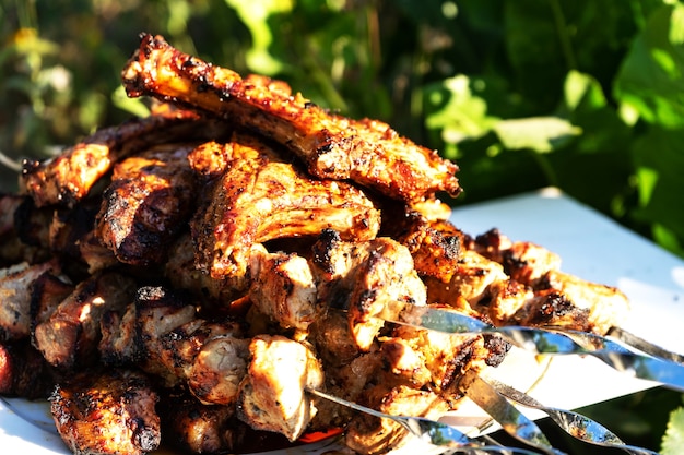 Barbecue on the grill. Ready-made pieces of meat on skewers.