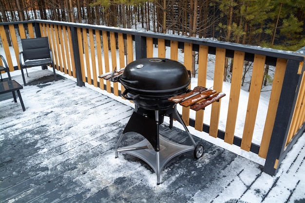 Barbecue grill on the terrace of a country house in the forest