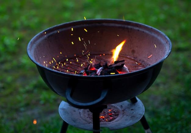 Barbecue grill with fire on nature, outdoor, close up
