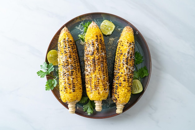 Barbecue and grilled corn with cheese and lime