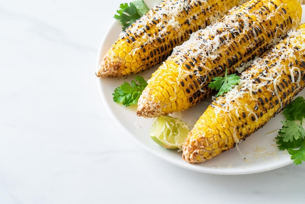 Barbecue and grilled corn with cheese and lime