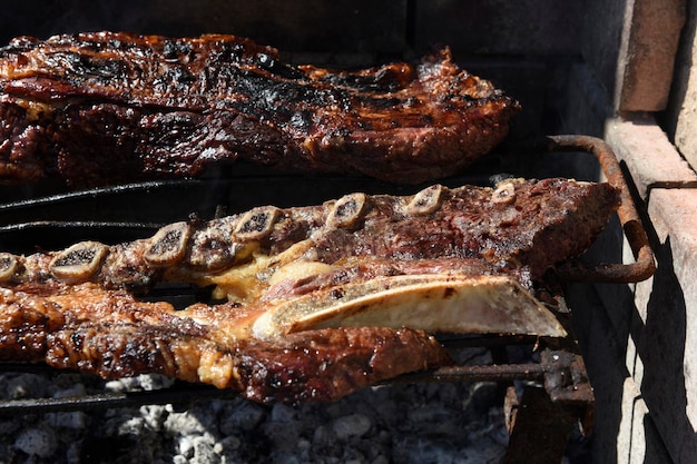 Photo barbecue grilled sausages and cow meat traditional argentine cuisine