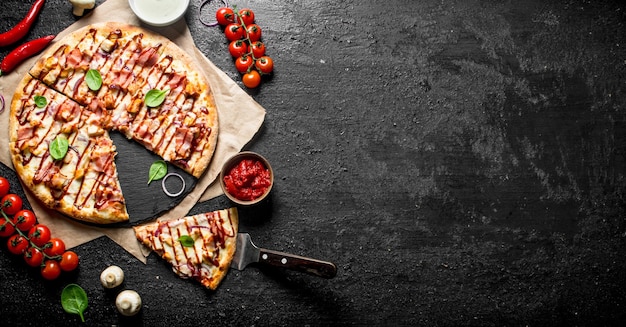 Barbecue pizza with spinach leaves cherry tomatoes and cheese sauce