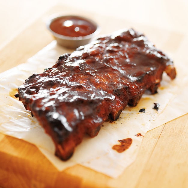 Barbecue ribs with sauce on a wooden board