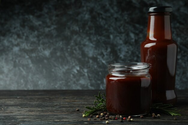 Barbecue sauce and spices on wooden table