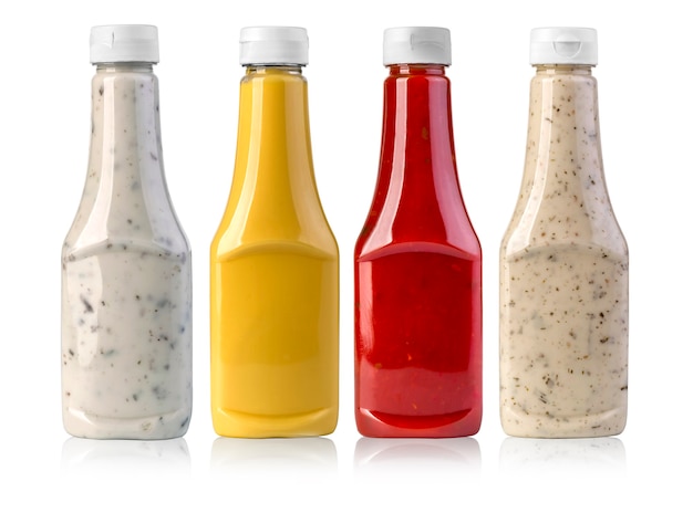 Photo barbecue sauces in glass bottles on white