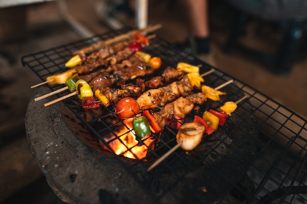 Spiedini di barbecue grigliati su griglie a carbone a casa