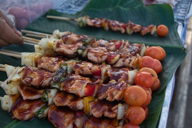 Barbecue stick on a green banana leaf