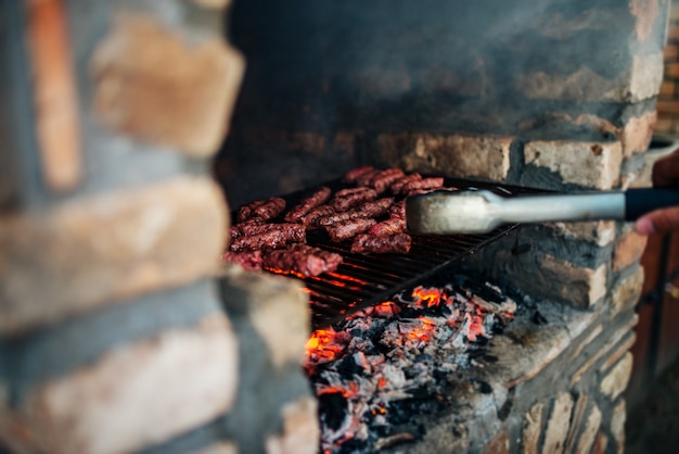 Photo barbecue on stone grill fireplace outdoors. close-up.