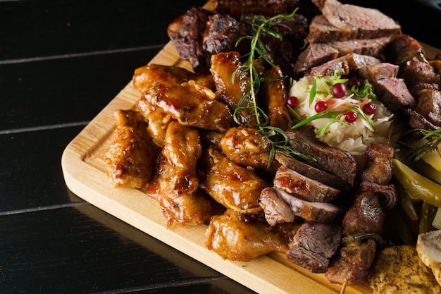 Barbecue tasty meat on black plate