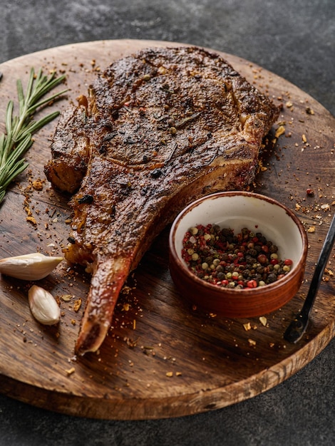 Barbecue tomahawk steak on cutting board steak on the bone\
succulent grilled tomahawk beef steak