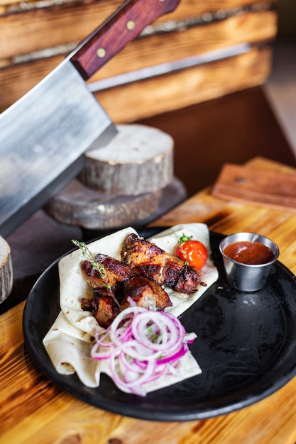 Barbecue with onions in pita bread and sauce