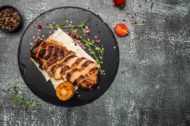 Barbecued chicken breasts on slate plate Roasted Chicken fillet grilled chicken fillets with vegetables banner menu recipe place for text top view