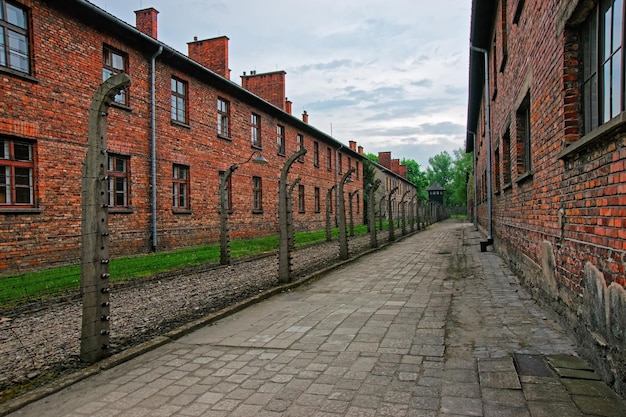 Barbed wire and barracks of Auschwitz concentration camp, Poland.