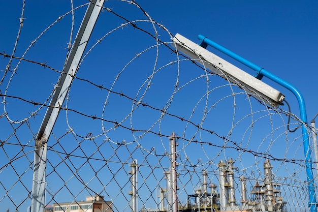 Barbed wire in the fence of an industry