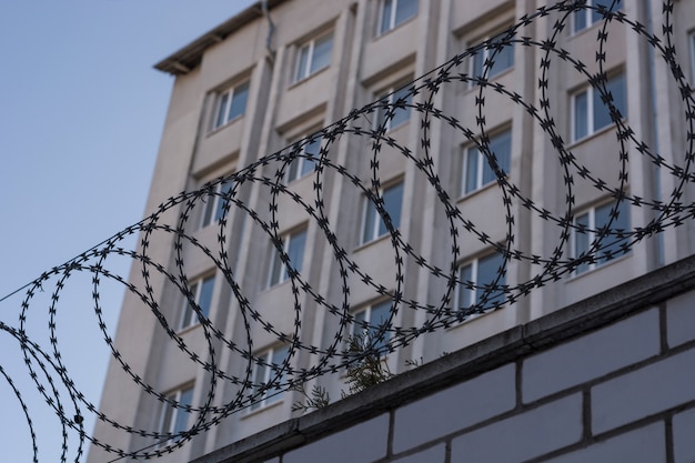 The barbed wire is taut on the fence with coils