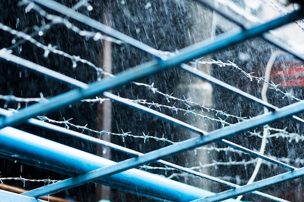 壁に有刺鉄線が取り付けられ、大雨が降りました。