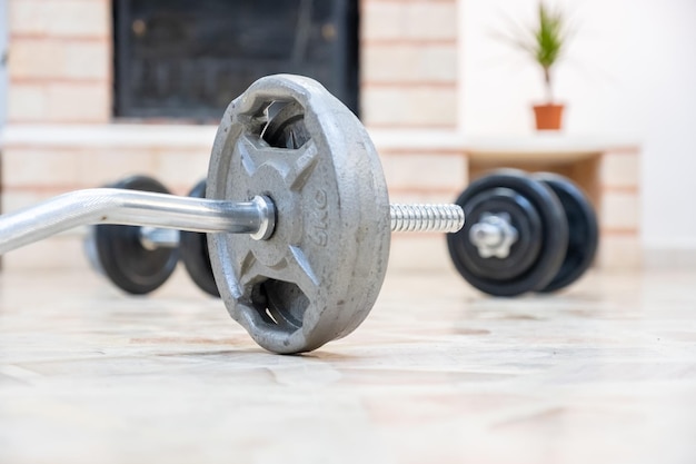 Barbell and dumbell on the floor for home workout