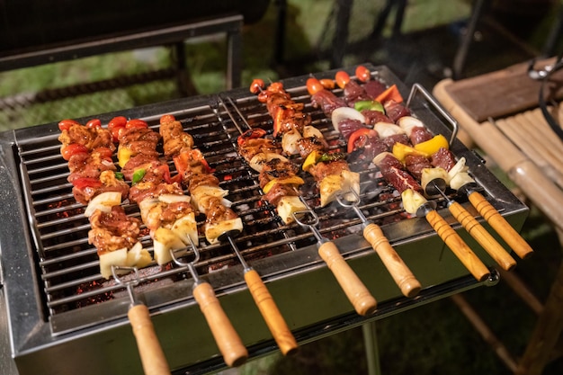 Barbeque skewers meat with vegetable grilling on charcoal bbq grill in backyard