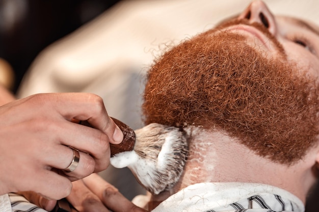 Barber and bearded man in barber shop