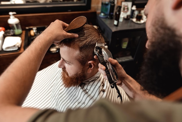 Barber and bearded man in barber shop