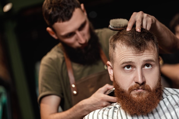 Barber and bearded man in barber shop