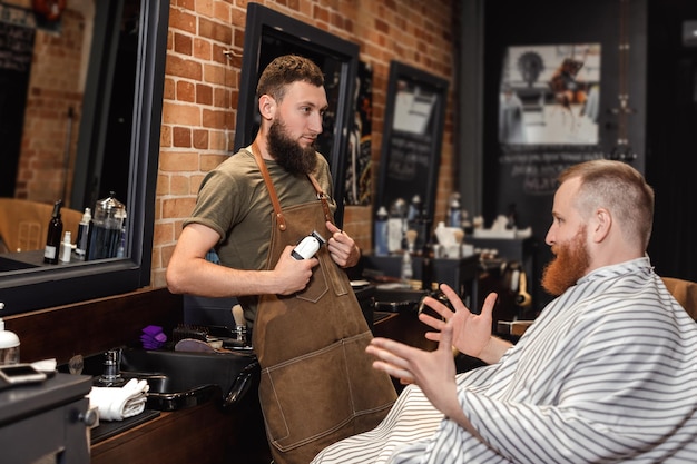 Barber and bearded man in barber shop