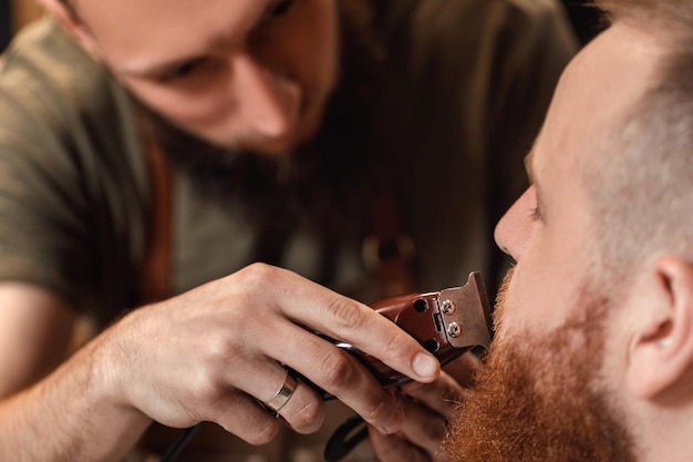 Barber and bearded man in barber shop