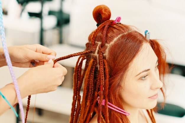 Barber braids dreadlocks. African braids are gathered in the tail. kanekalon