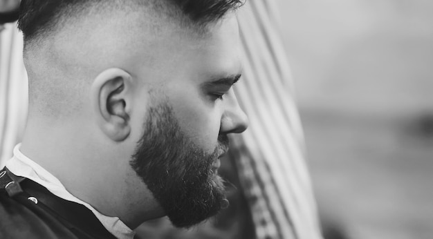 Barber cuts bearded man's