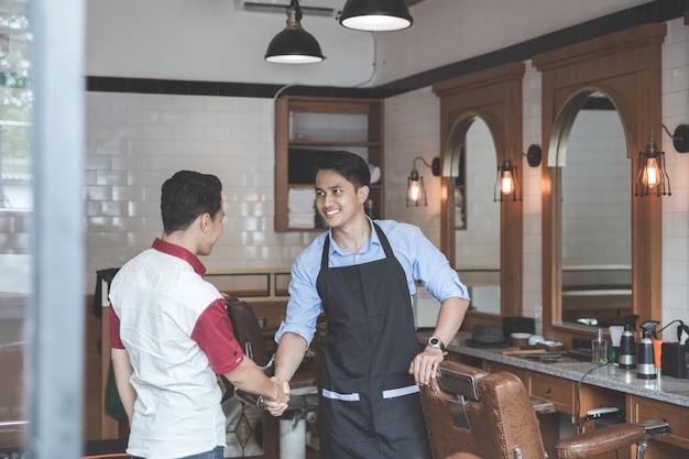 Barber and his client shaking hands