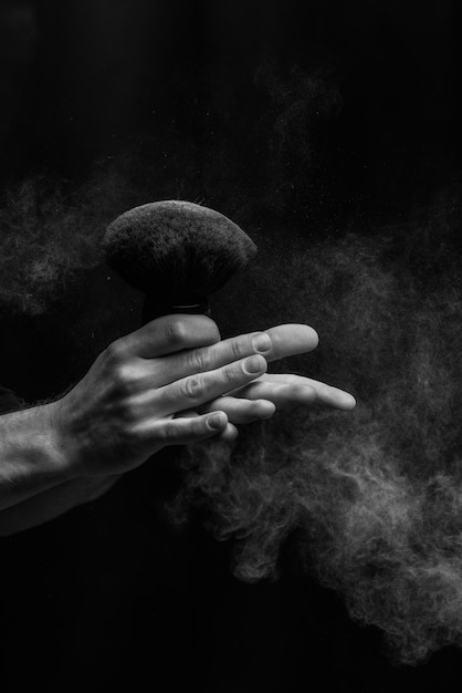 Barber holding a brush for powder