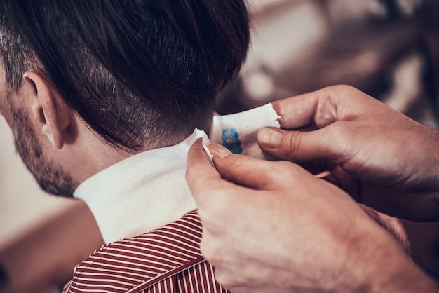 Barber Is Taping Clients Nape Before Haircutting.