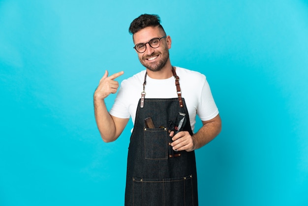 Barber man in an apron giving a thumbs up gesture