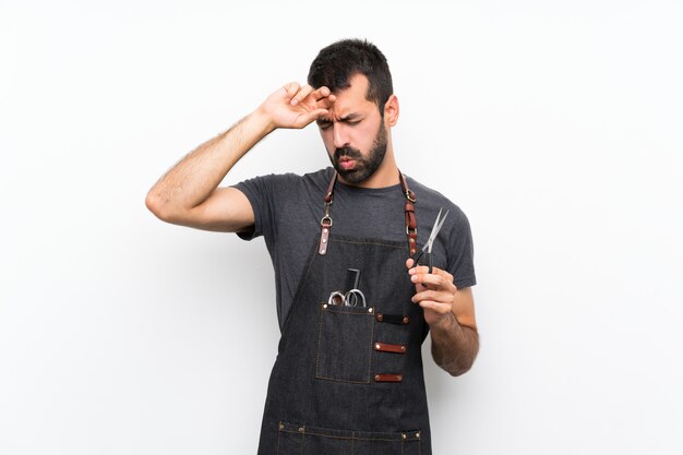 Barber man in an apron with tired and sick expression