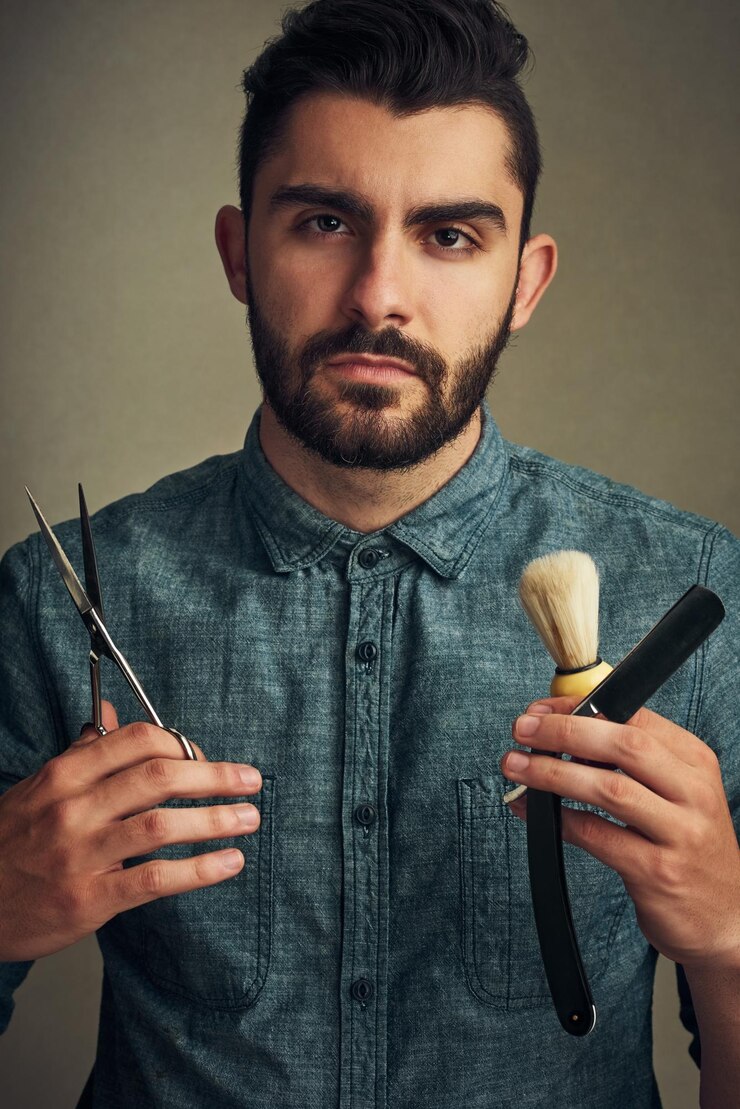 फोटो barber portrait and scissors with straight razor for hair care hairstyle and grooming as man in studio male person professional and personal hygiene for beauty haircut and barbershop with tools