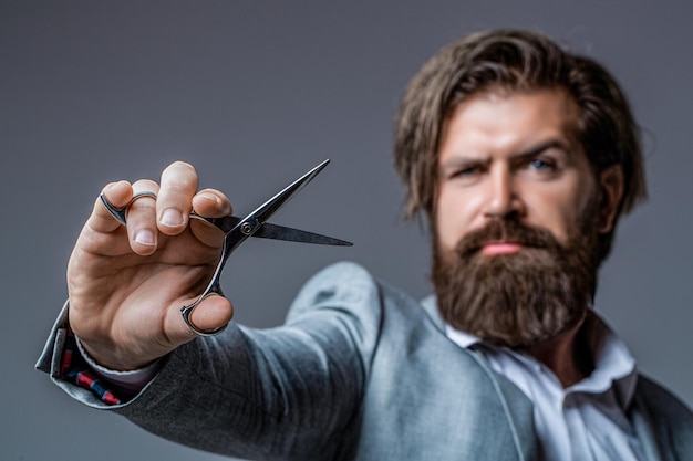 Barber scissors barber shop Brutal man moustache Portrait of stylish professional hairdresser with beard Man holding scissors Barber scissors barber shop Barber scissors Vintage barbershop