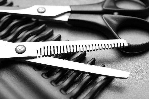 Barber set with comb and scissors on grey background close up