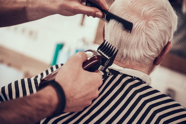 Barber Shaves Grey Haired Adult Nape With Razor