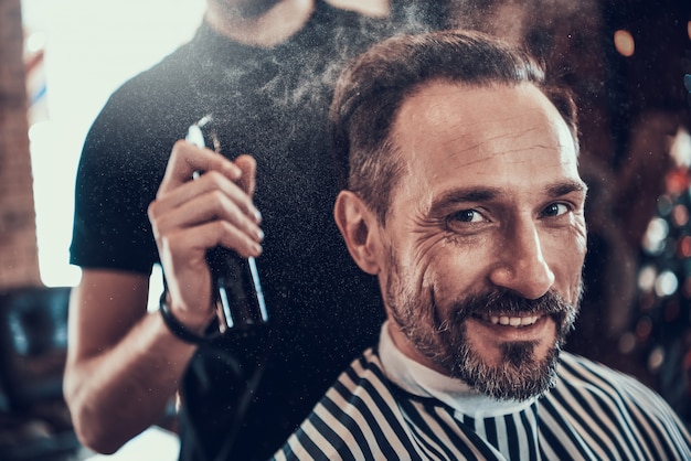 Barber Shaves Handsome Smiling Man With Razor.